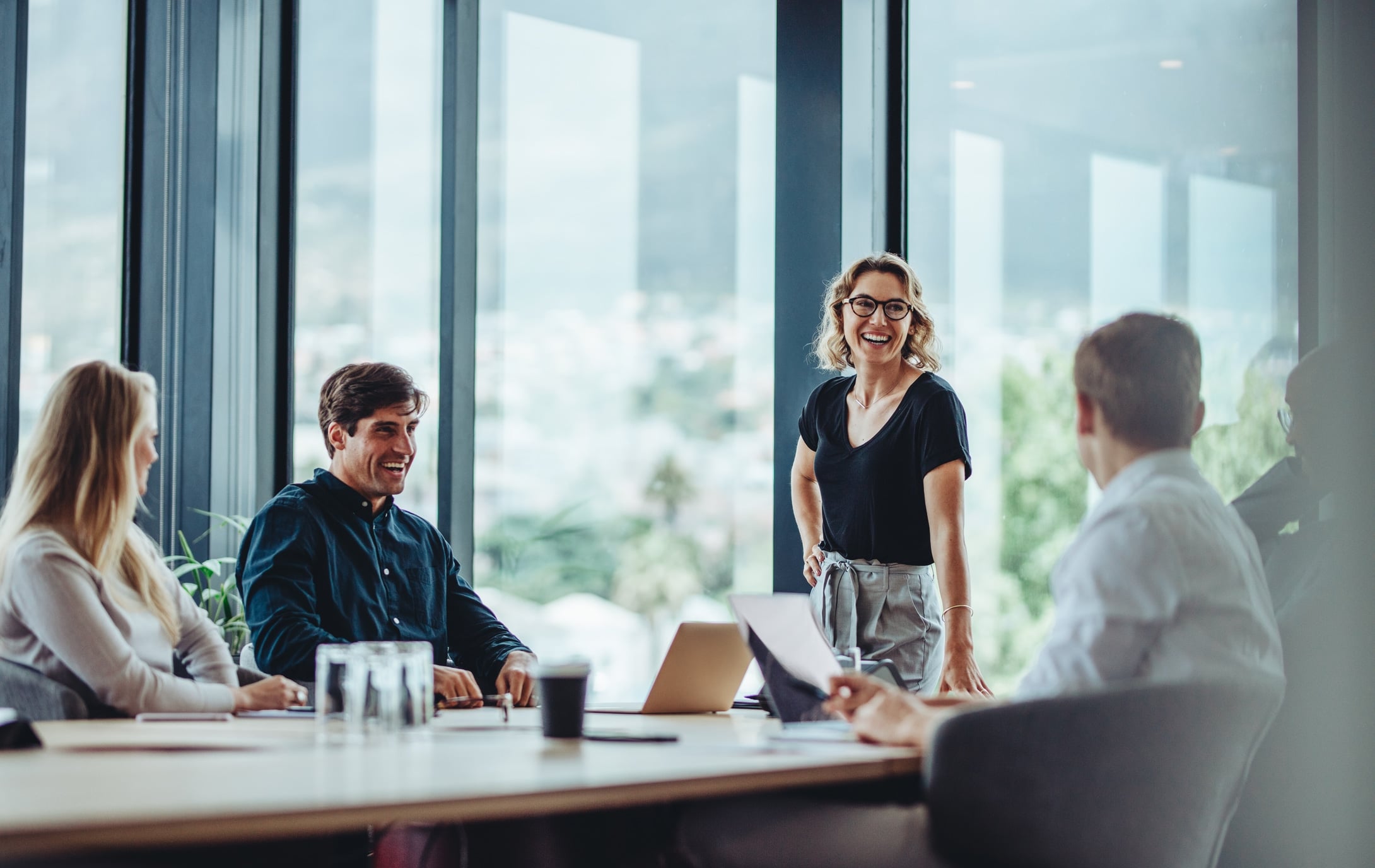 A small team talking around a meeting table