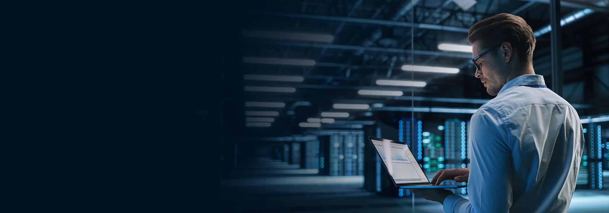 A person with a laptop in a data centre